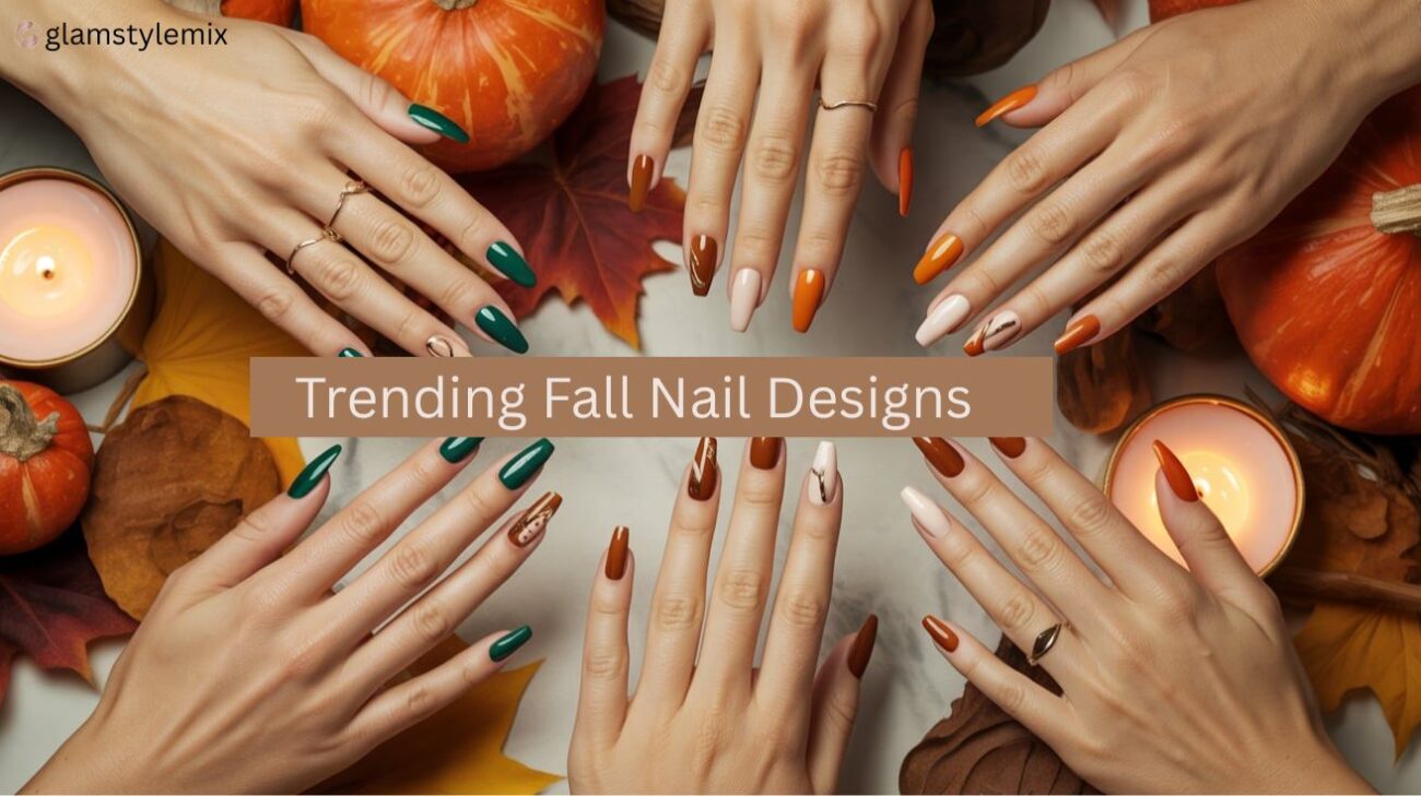 Hands with autumn-inspired nail designs in burnt orange, forest green, and beige tones surrounded by pumpkins, candles, and fall leaves — showcasing trendy fall manicure ideas for 2025.