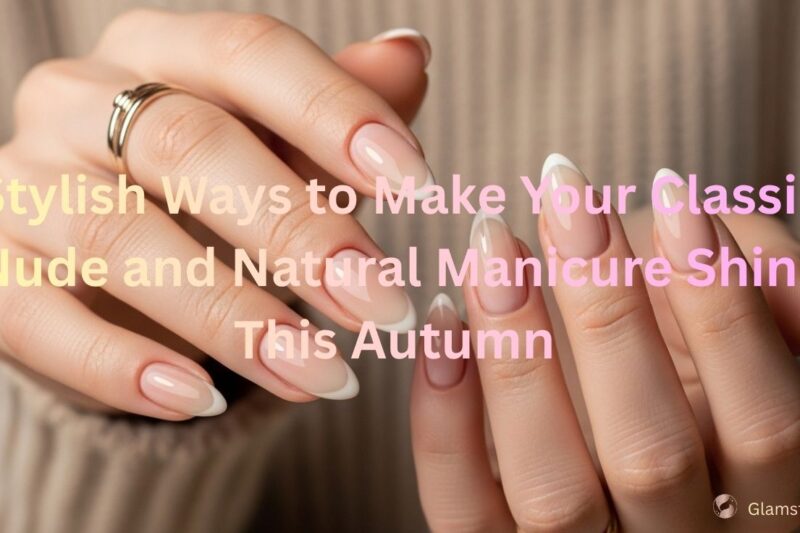 Hands with a nude and natural manicure featuring soft beige and light pink tones, shaped in almond style, with subtle French-inspired detailing, shown against a cozy neutral sweater background.